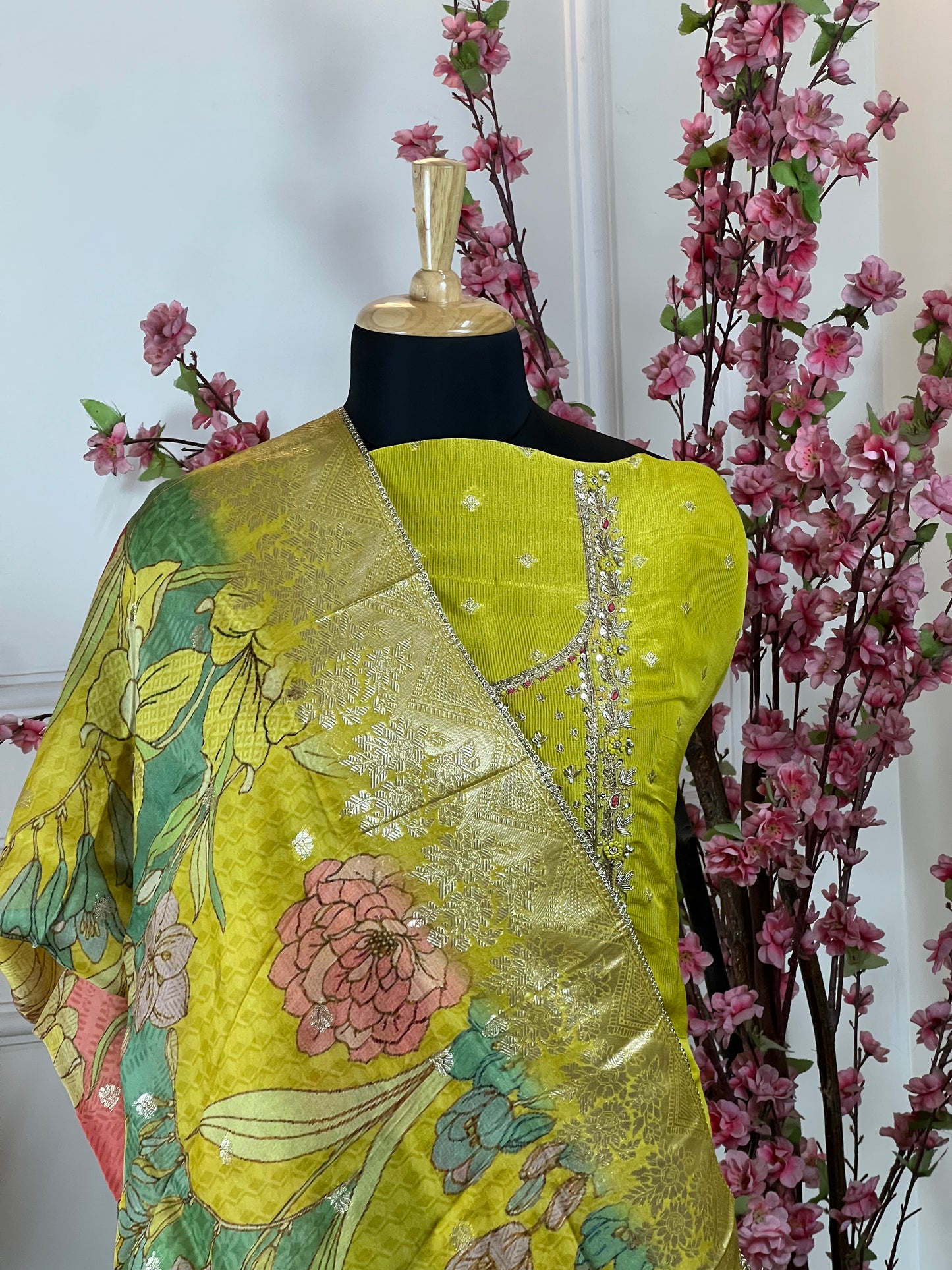 Top: Pure ivory silk with dabka, pearl handwork, knot work and sequins; Bottom: Pure silk santoon; Dupatta: Pure organja printed with Banarasi work and tassels;