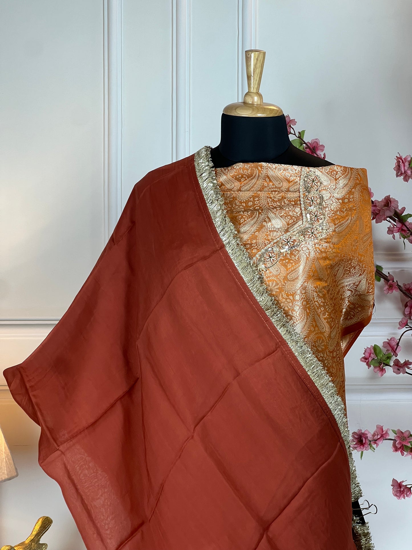 Top: Pure Banarasi brocket with dabka, sequins, pearl and thread work on neck and sleeves; Bottom: Crape plain; Dupatta: Pure organja with fancy lace;