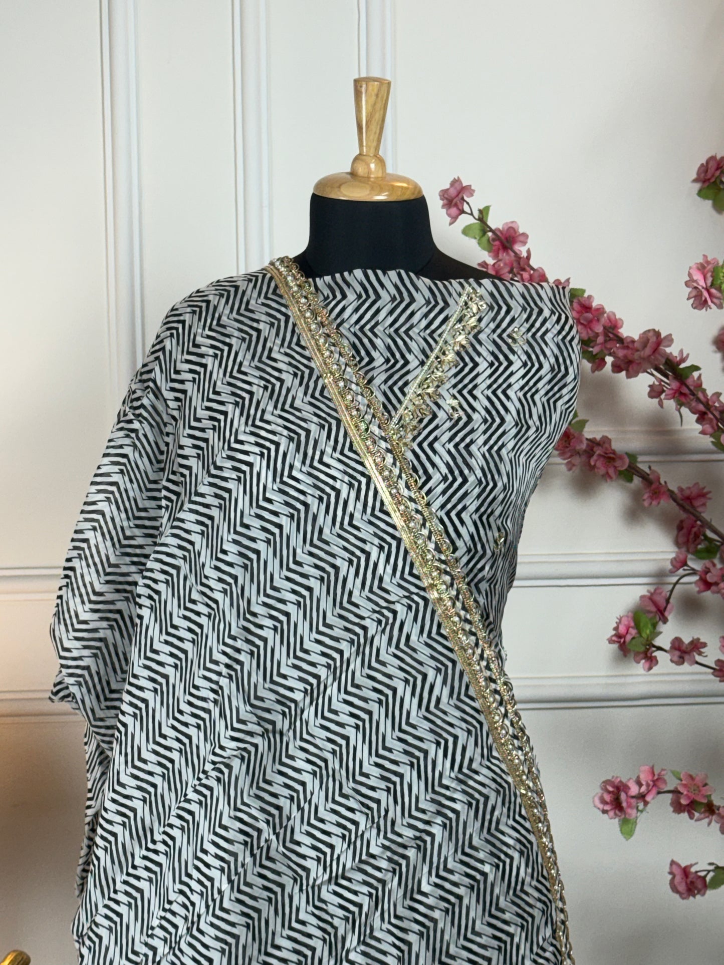Top: Pure and soft organja printed with dabka, pearl, nalki V-shape neck work; Bottom: Pure crape with payal work and buti; Dupatta: Pure organja printed with heavy lace;
